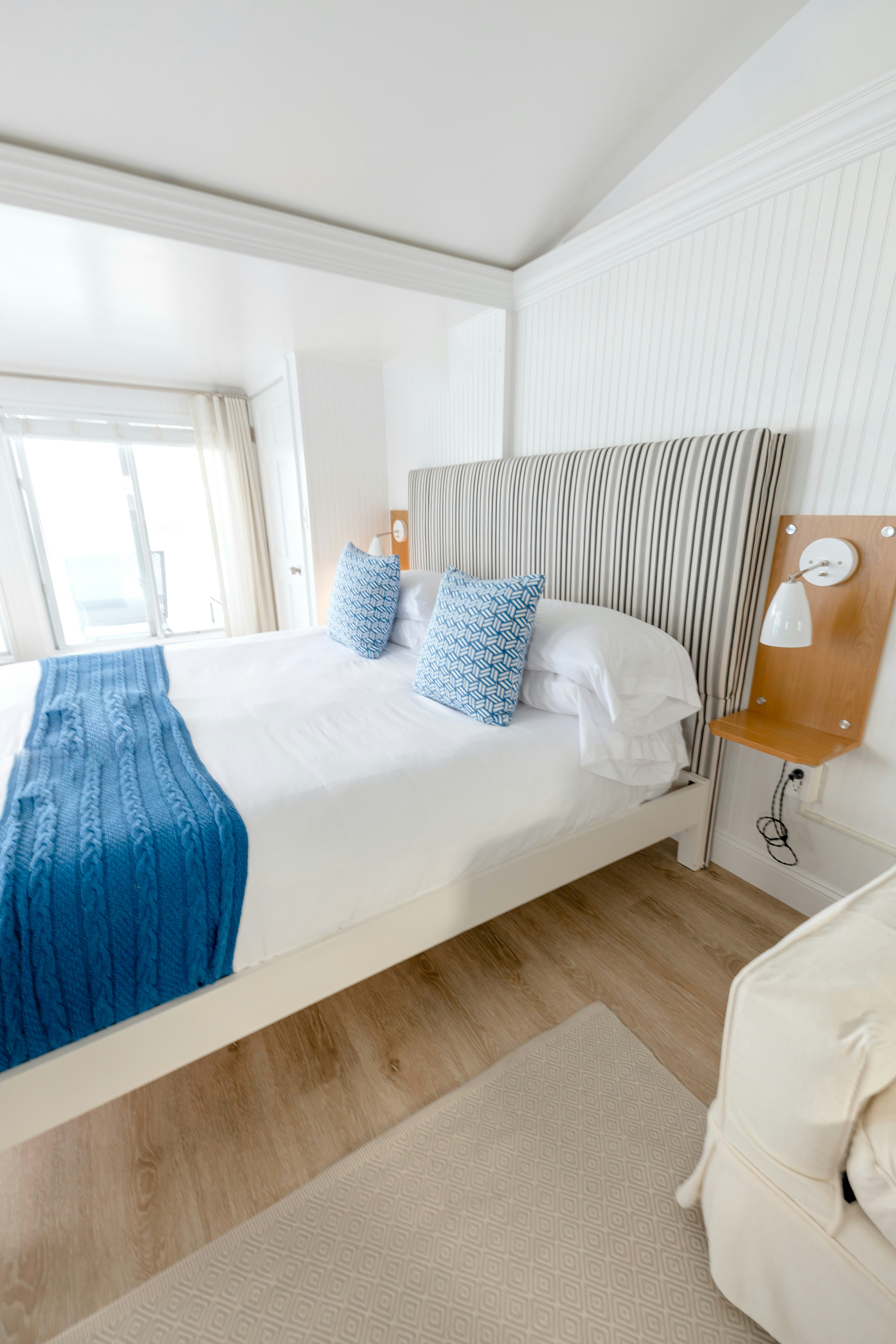 Coastal Living Collection mood photo showing a bed with a throw blanket