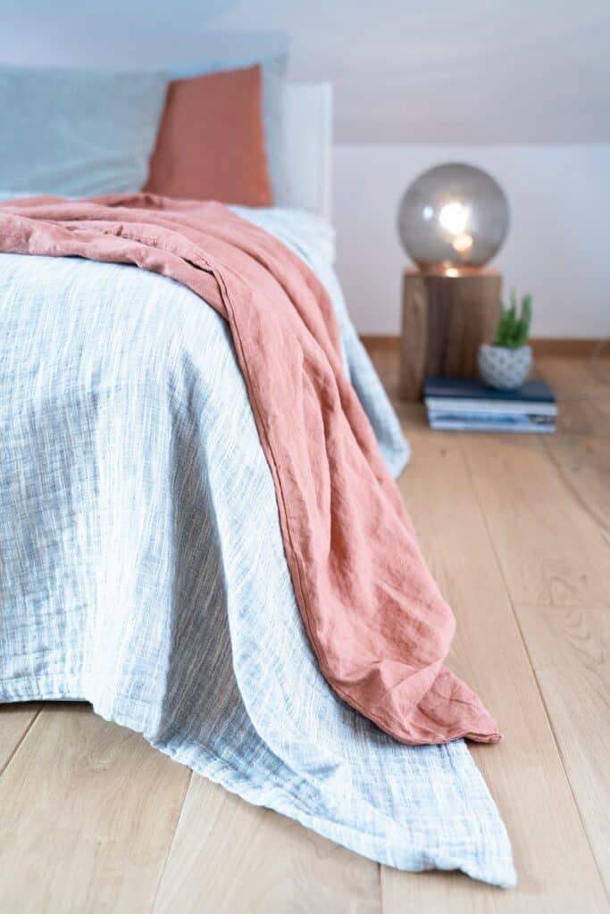 Coastal Living Collection Bedroom Mood Image of a Bed with a Linen Quilt
